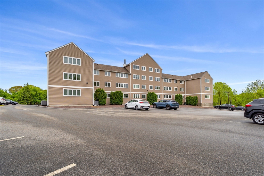 36 Dunham Road, Unit 109 Beverly, MA 01915 - Photo 22 of 22 a view of a street with a building in the background