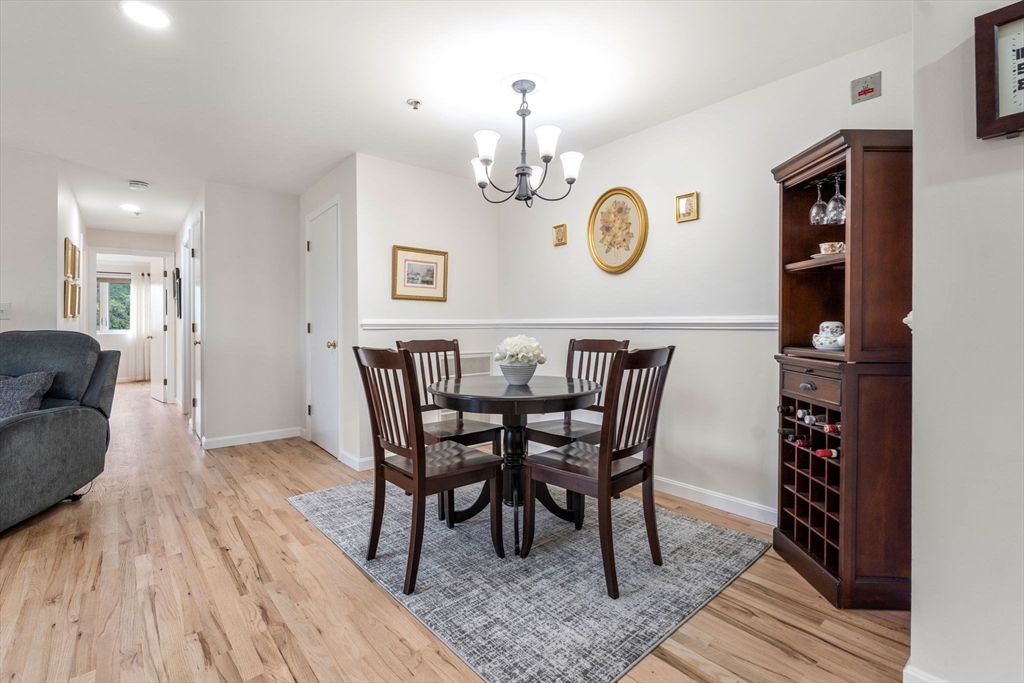 36 Dunham Road, Unit 109 Beverly, MA 01915 - Photo 7 of 22 a view of a dining room with furniture and wooden floor