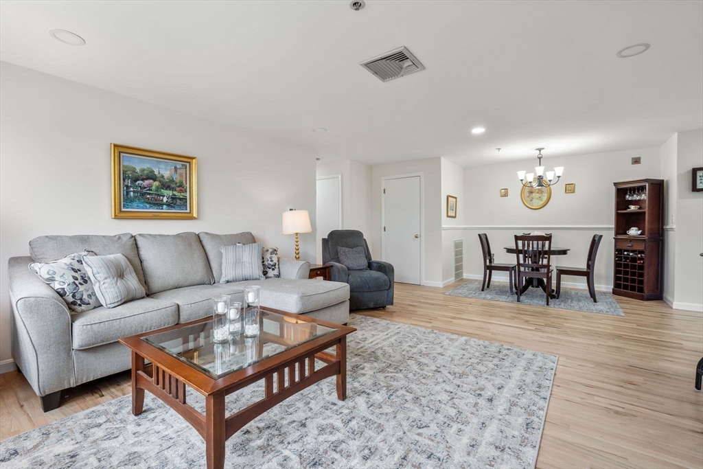 36 Dunham Road, Unit 109 Beverly, MA 01915 - Photo 9 of 22 a living room with furniture and wooden floor