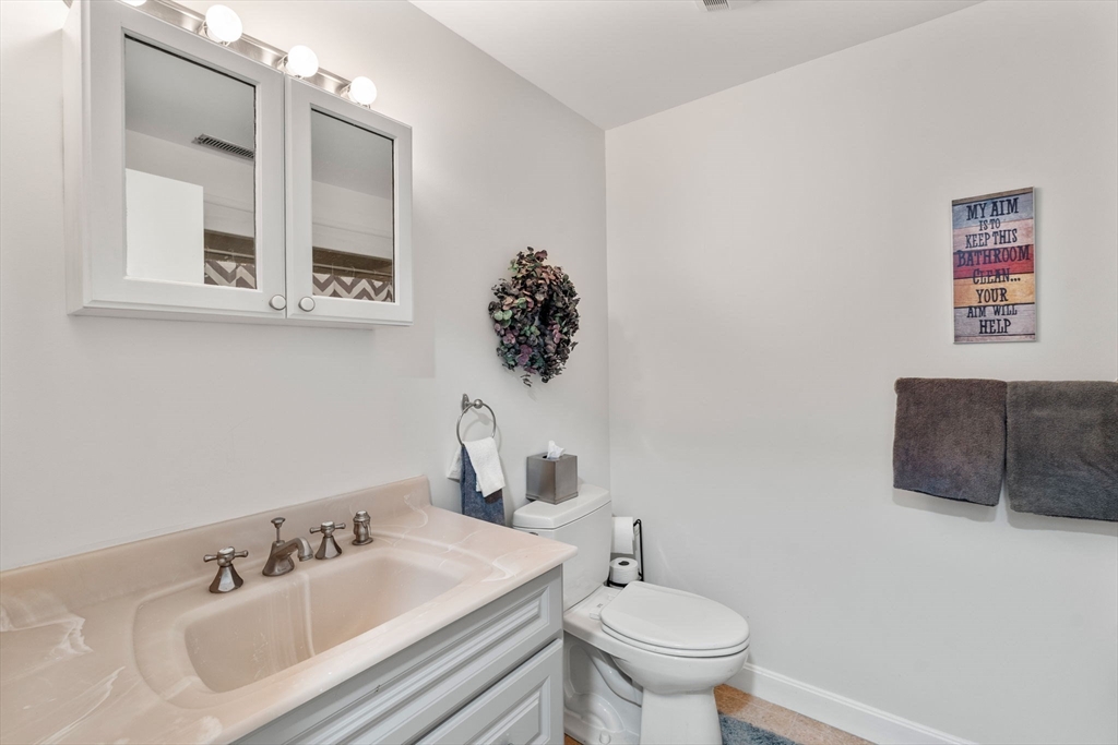 36 Dunham Road, Unit 109 Beverly, MA 01915 - Photo 10 of 22 a bathroom with a toilet sink and mirror