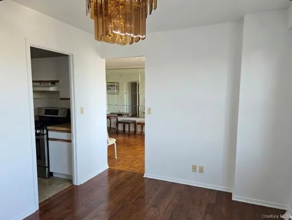 wooden floor in a kitchen and an empty room