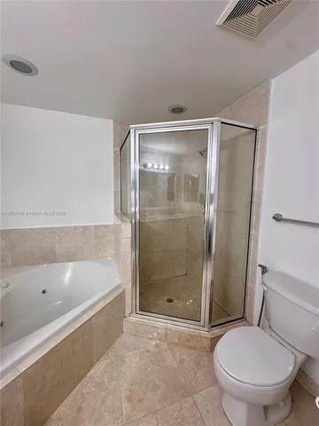 a bathroom with a toilet and a bath tub