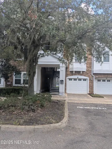 a view of a house with a yard and garage