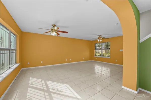 a view of a big room with windows and chandelier