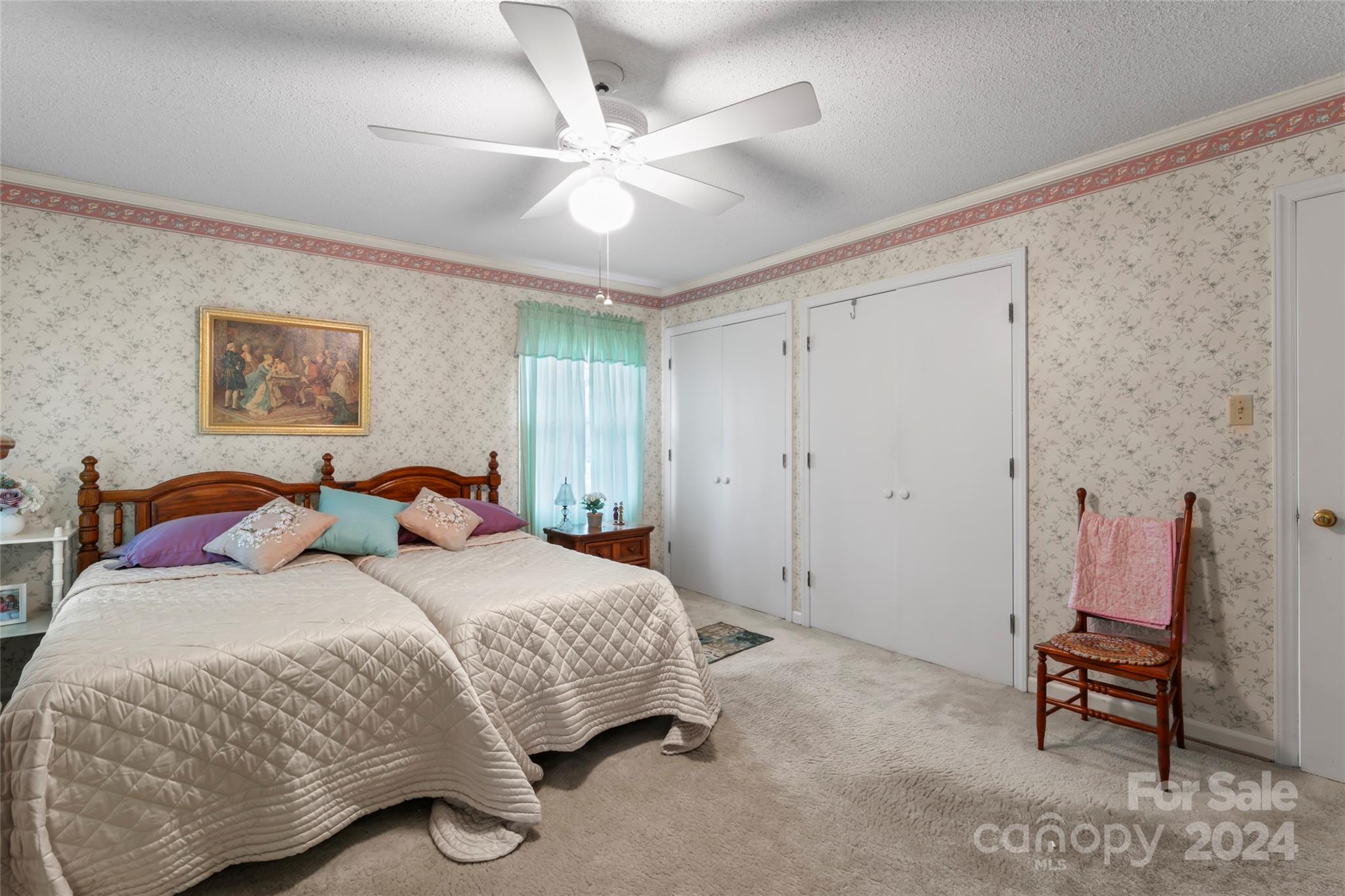 950 Arrowhead Drive Rock Hill, SC 29730 - Photo 28 of 38 a bedroom with a large bed and a chandelier