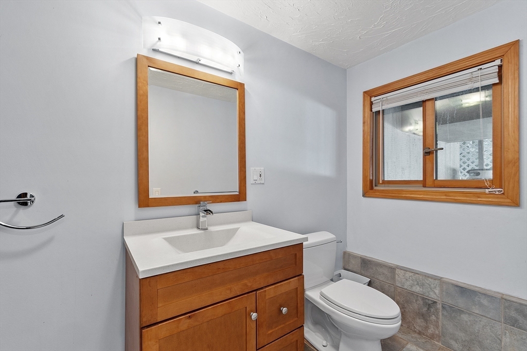 18 Lancaster Crossing Road Salem, NH 03079 - Photo 25 of 31 a bathroom with a toilet a sink and mirror