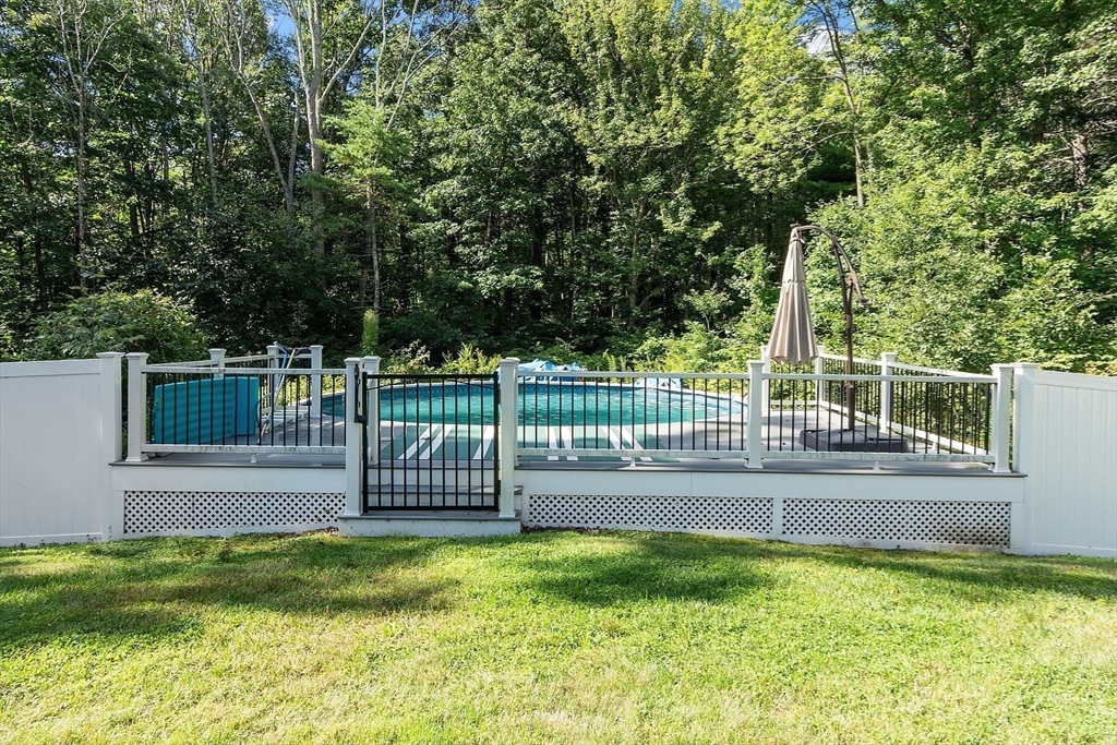 18 Lancaster Crossing Road Salem, NH 03079 - Photo 28 of 31 a view of a deck with a small yard and large trees