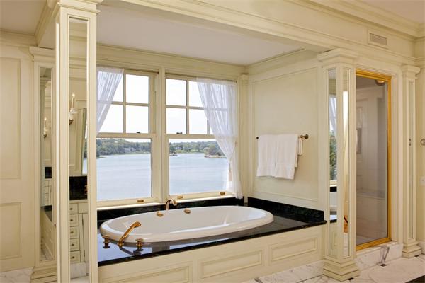 63 Nichols Road Cohasset, MA 02025 - Photo 14 of 22 a bathroom with a granite countertop tub a sink and a large mirror