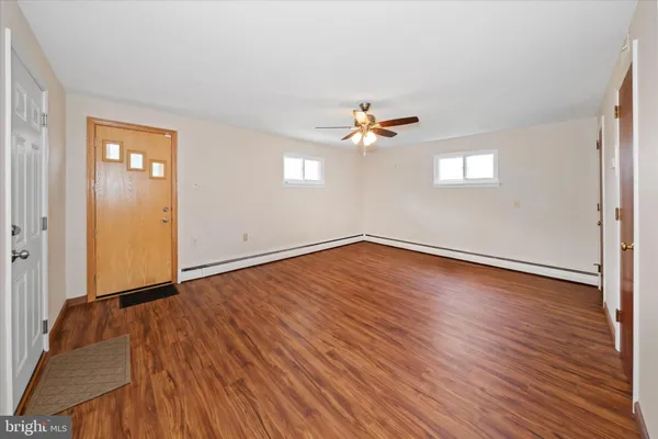 wooden floor in an empty room with a window