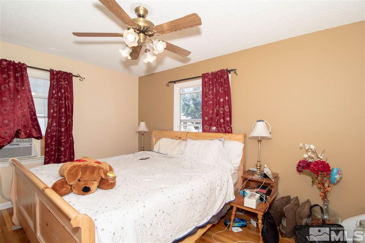 520 Claremont Street Reno, NV 89502 - Photo 12 of 22 a bedroom with a bed and a chandelier