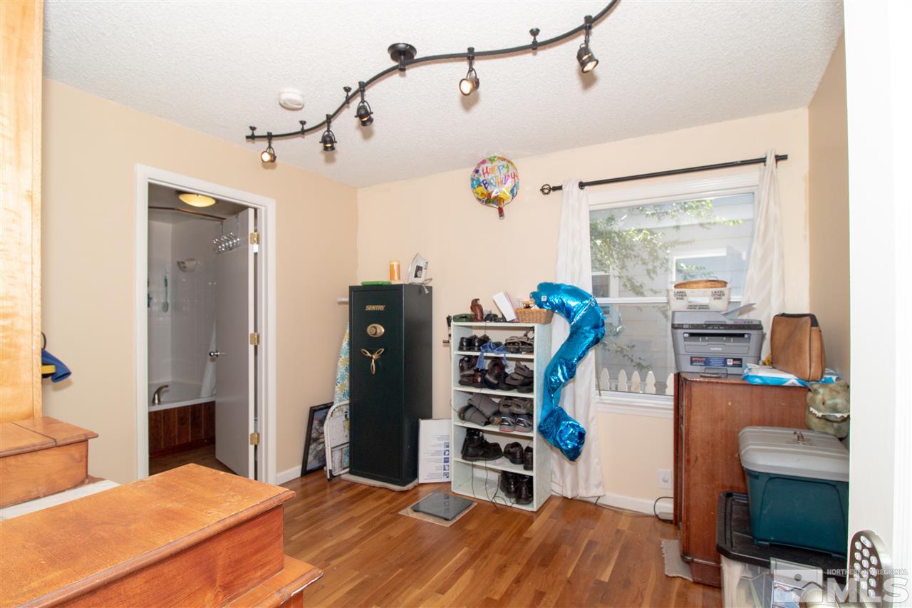520 Claremont Street Reno, NV 89502 - Photo 14 of 22 a bedroom with a bed and wooden floor