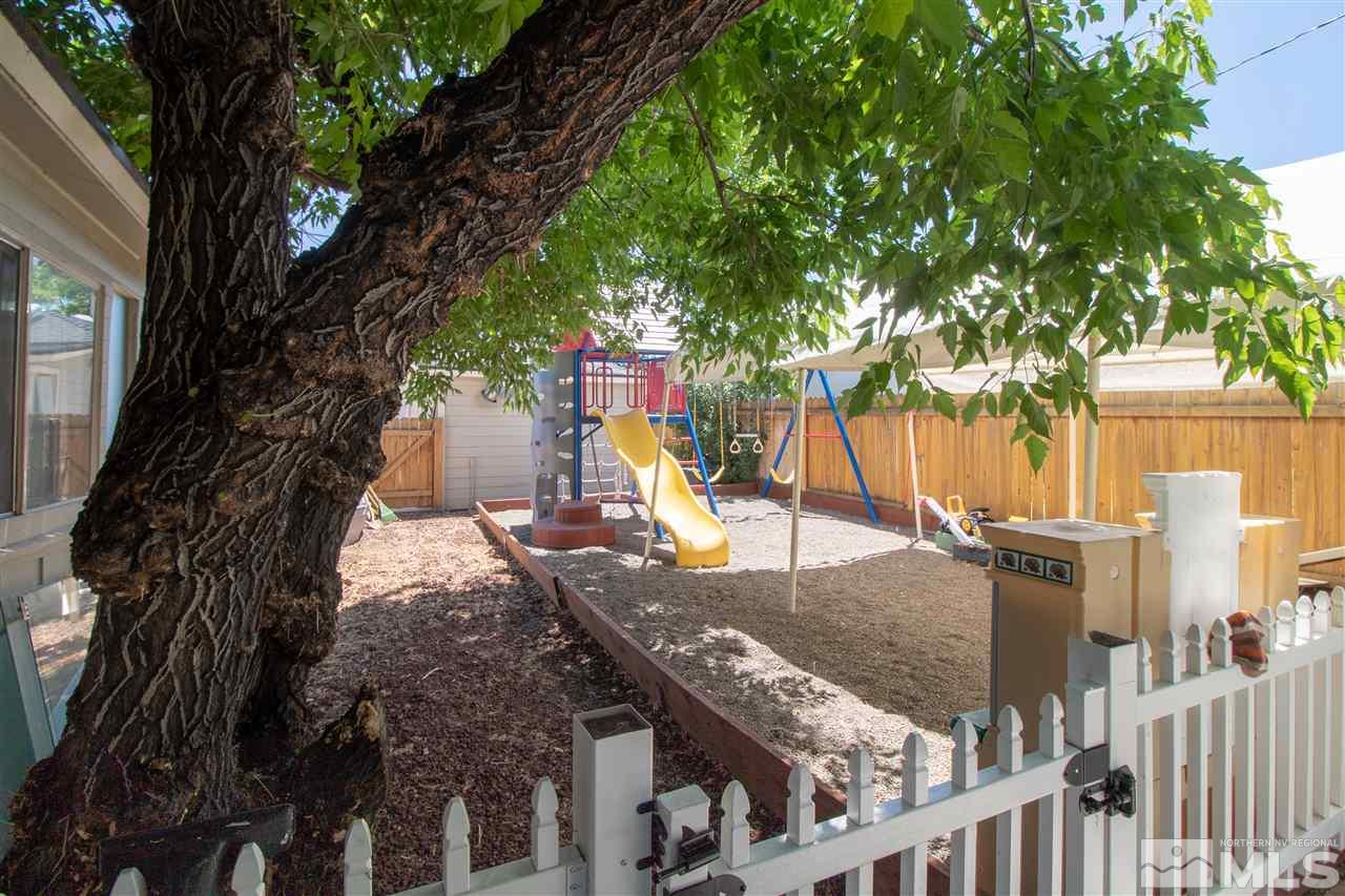 520 Claremont Street Reno, NV 89502 - Photo 16 of 22 a view of a house with a tree and wooden fence