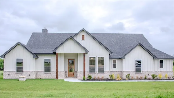 a front view of house with yard and green space