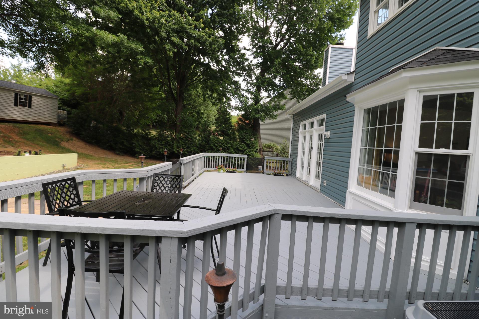 11901 Rustic Farm Court Germantown, MD 20874 - Photo 118 of 134 Spacious deck surrounded by greenery.