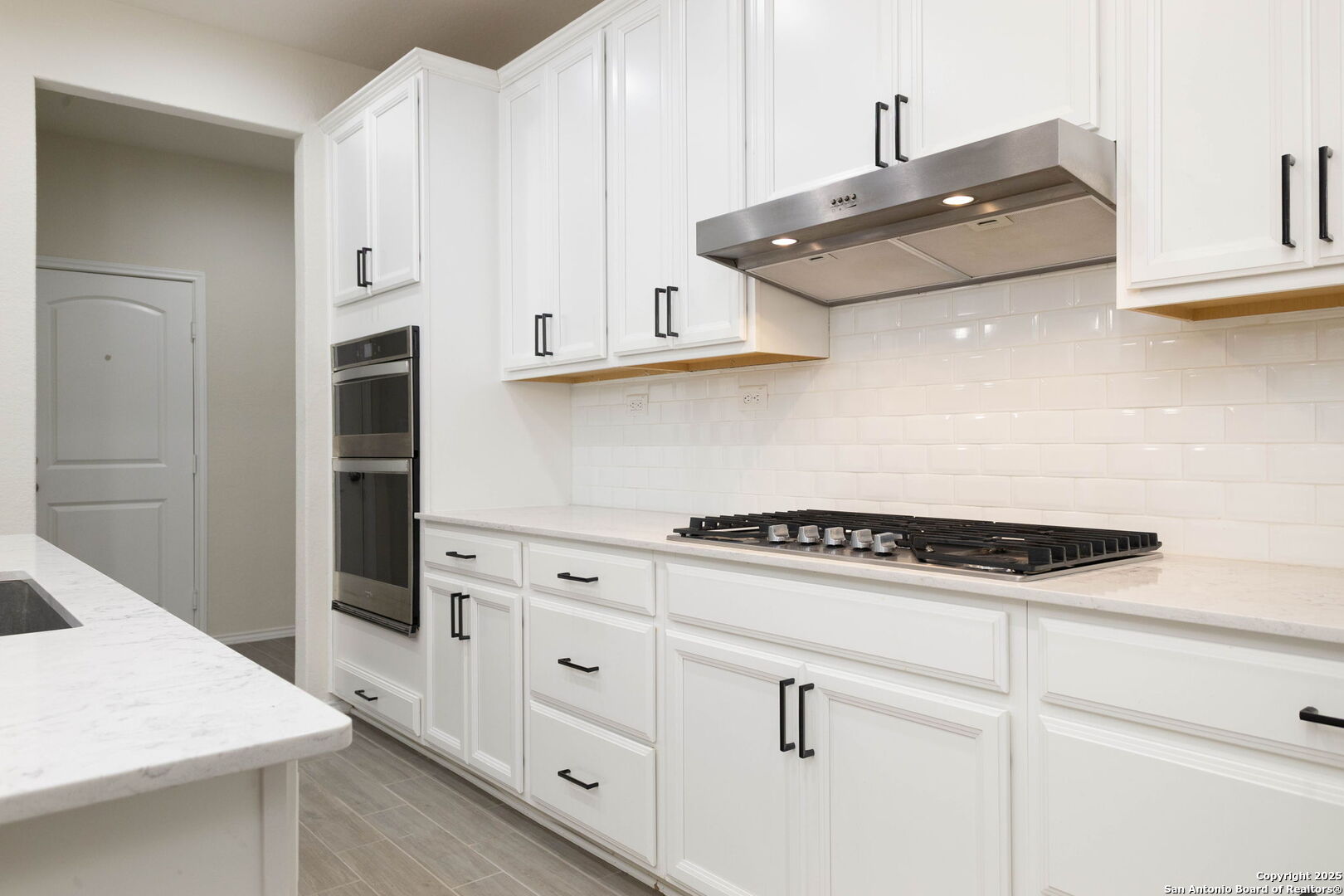 353 Aberdeen Boerne, TX 78015 - Photo 14 of 36 a kitchen with white cabinets and appliances