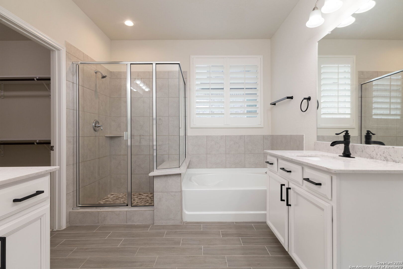 353 Aberdeen Boerne, TX 78015 - Photo 19 of 36 a bathroom with a tub sink shower and two mirror