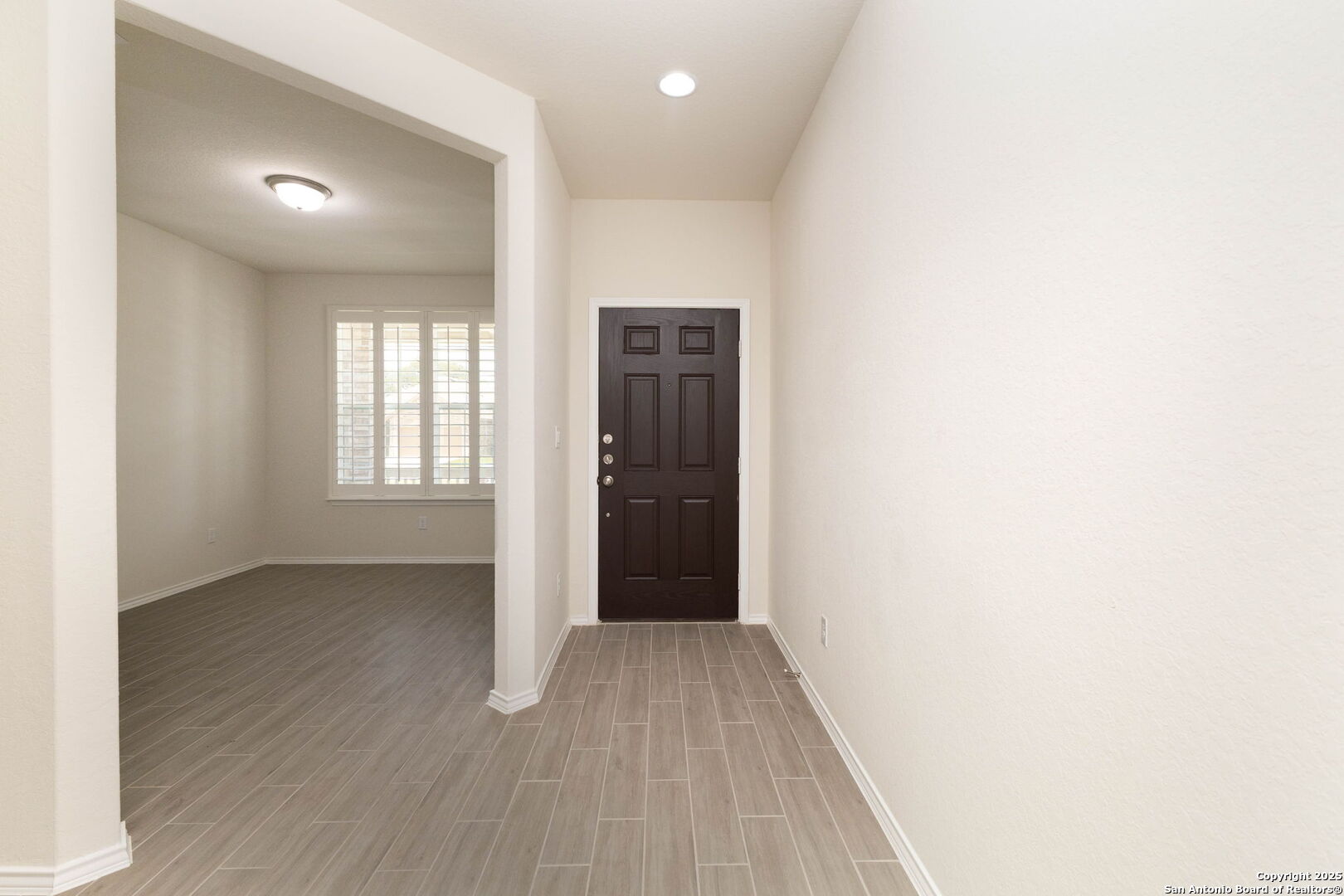 353 Aberdeen Boerne, TX 78015 - Photo 4 of 36 an empty room with wooden floor and windows