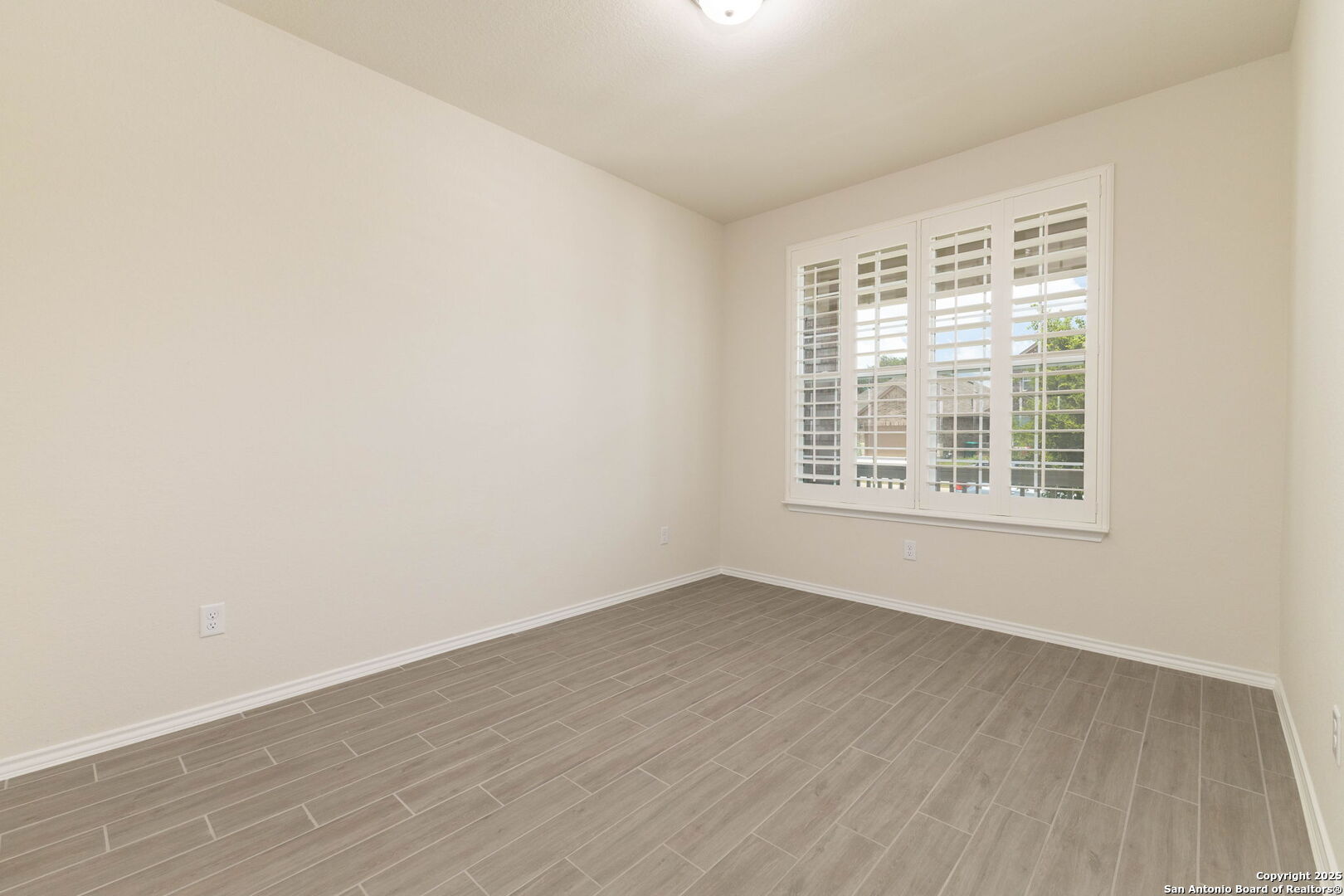 353 Aberdeen Boerne, TX 78015 - Photo 5 of 36 wooden floor in an empty room with a window