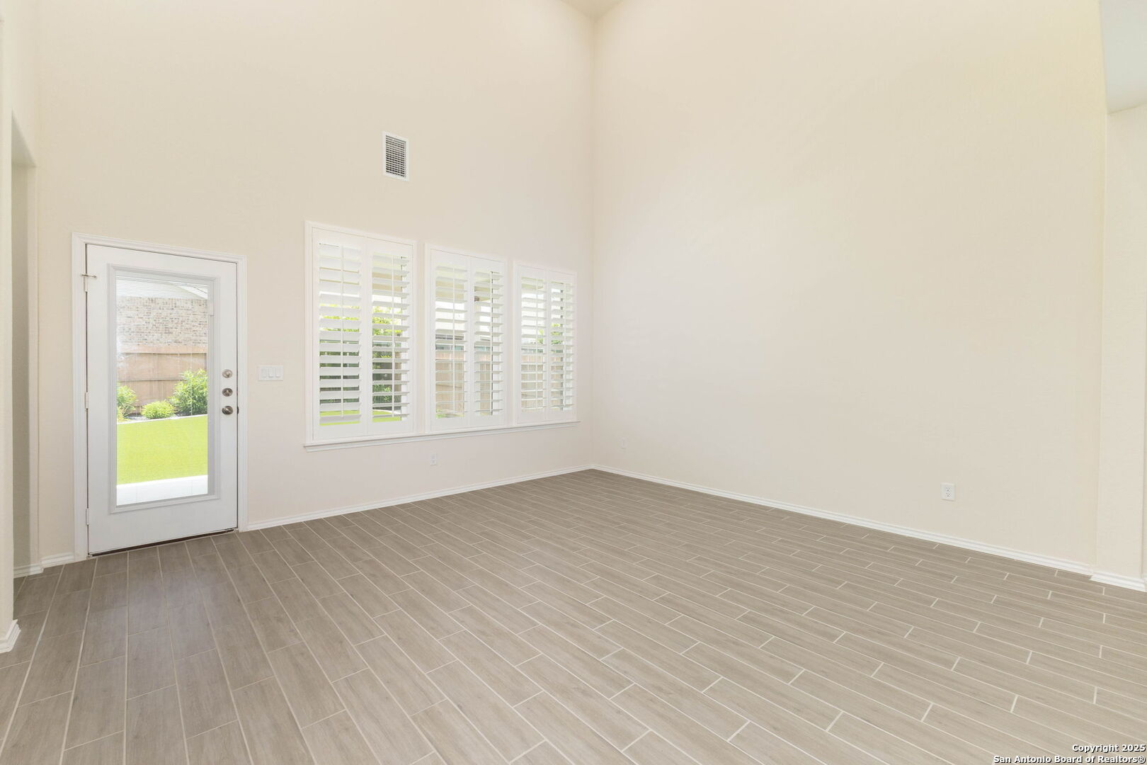 353 Aberdeen Boerne, TX 78015 - Photo 8 of 36 an empty room with wooden floor and windows