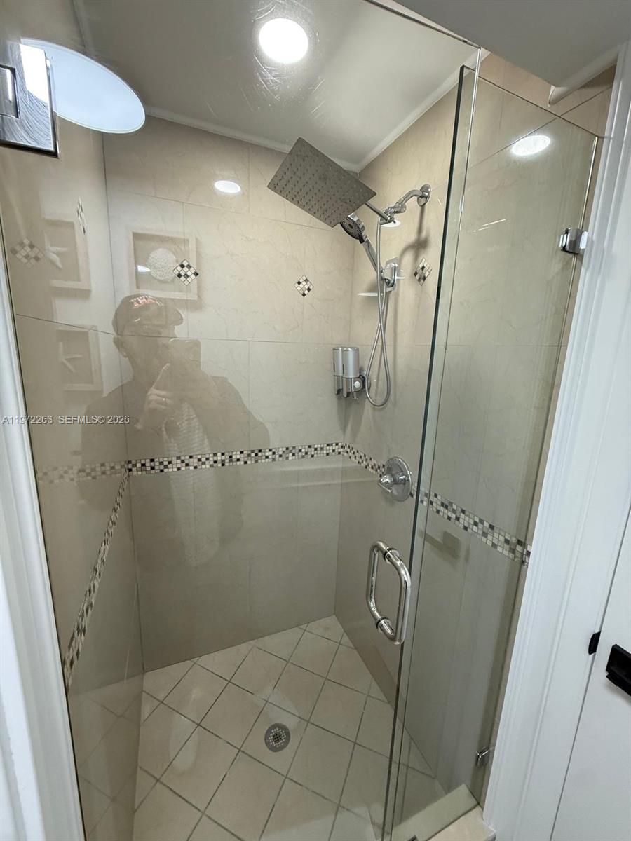 15445 Southwest 57th Street Miami, FL 33193 - Photo 38 of 78 a bathroom with a mirror and a shower