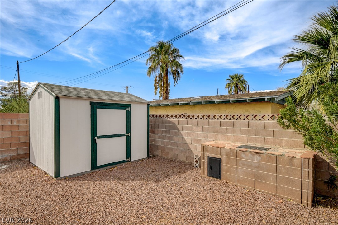 1401 Sharon Road Las Vegas, NV 89106 - Photo 68 of 73 A spacious backyard area includes a detached storage shed alongside a privacy block wall.