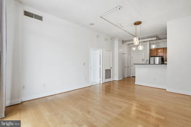 a view of a big room with windows and cabinet