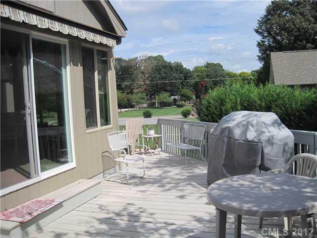 272 Spring Run Road Mooresville, NC 28117 - Photo 13 of 16 a view of a patio with table and chairs with wooden floor and fence