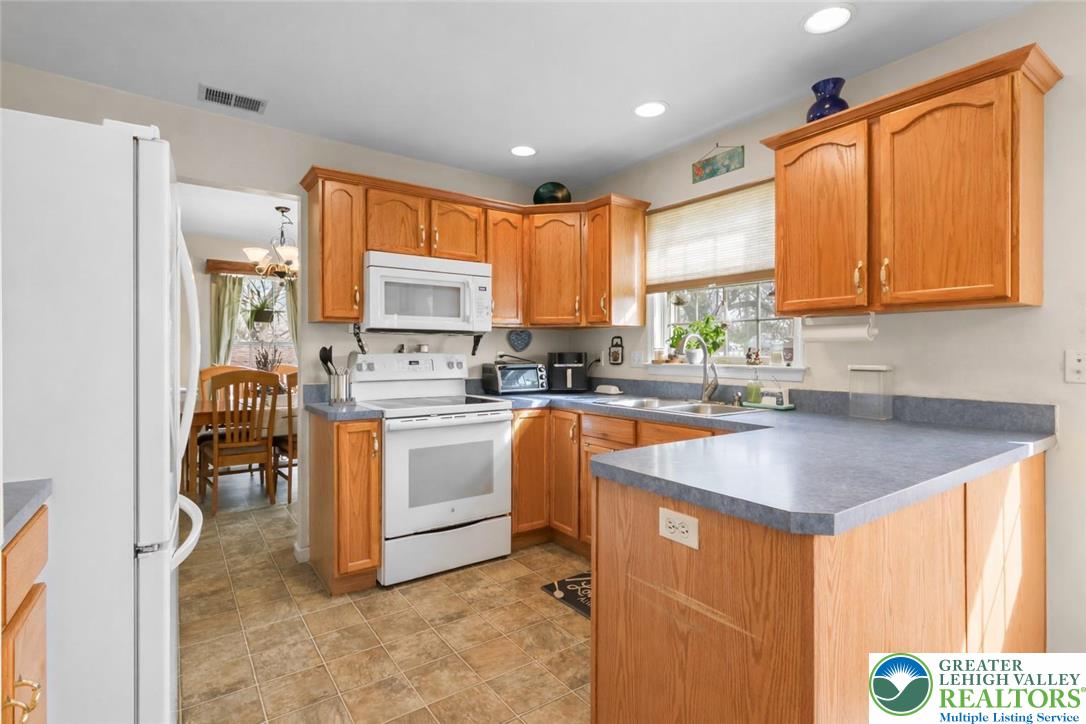 1712 9th Street Bethlehem, PA 18020 - Photo 11 of 38 a kitchen with granite countertop a sink appliances cabinets and a counter top space