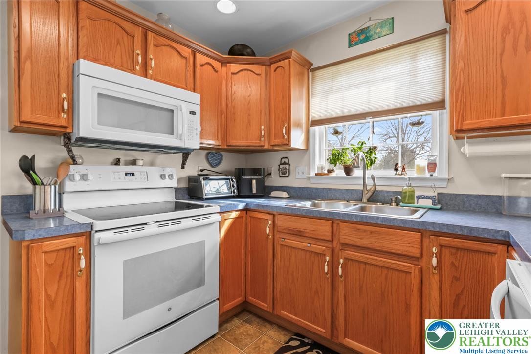 1712 9th Street Bethlehem, PA 18020 - Photo 12 of 38 a kitchen with stainless steel appliances granite countertop a sink a stove and cabinets