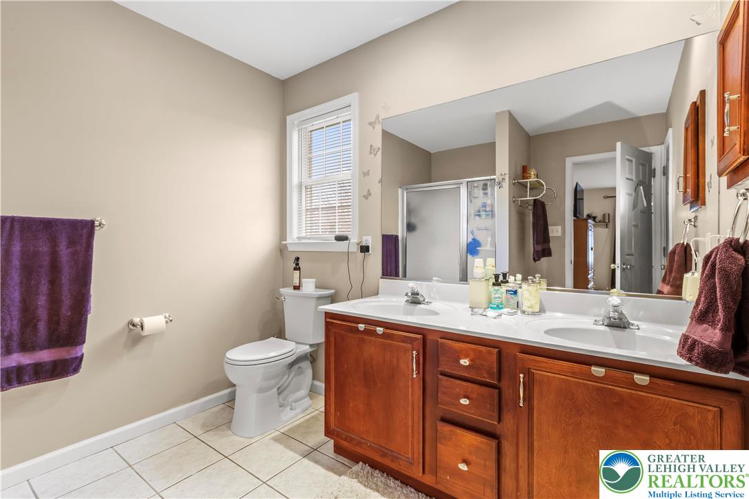 1712 9th Street Bethlehem, PA 18020 - Photo 21 of 38 a bathroom with a granite countertop sink toilet and mirror