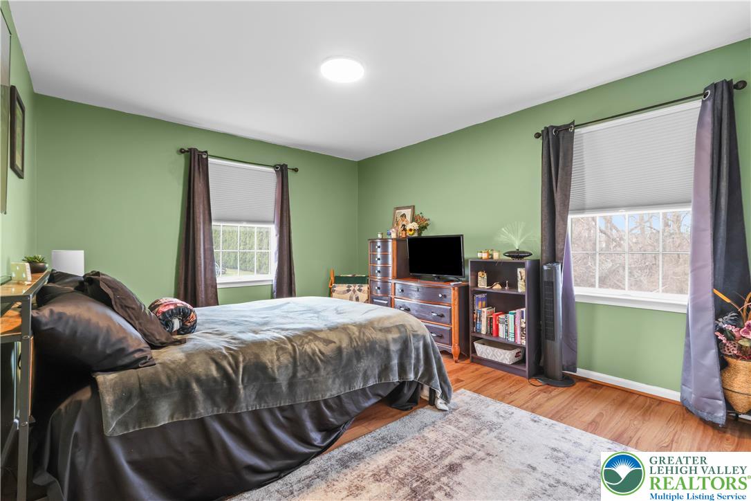 1712 9th Street Bethlehem, PA 18020 - Photo 24 of 38 a bedroom with a bed and a flat tv screen on dresser