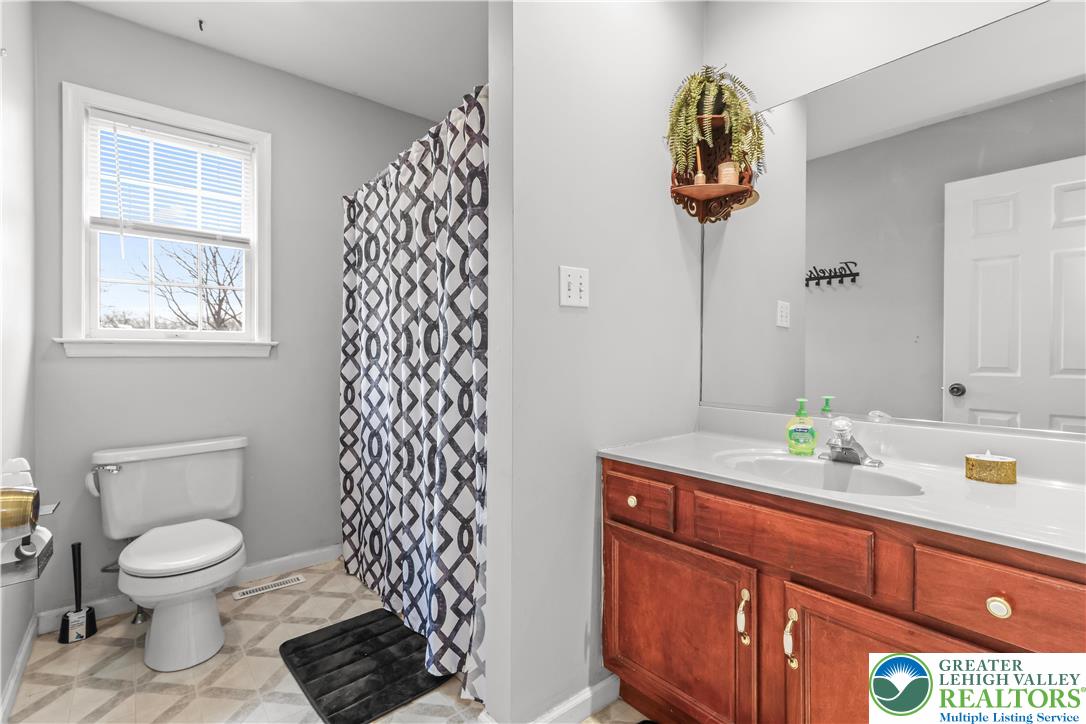 1712 9th Street Bethlehem, PA 18020 - Photo 27 of 38 a bathroom with a sink a toilet and mirror