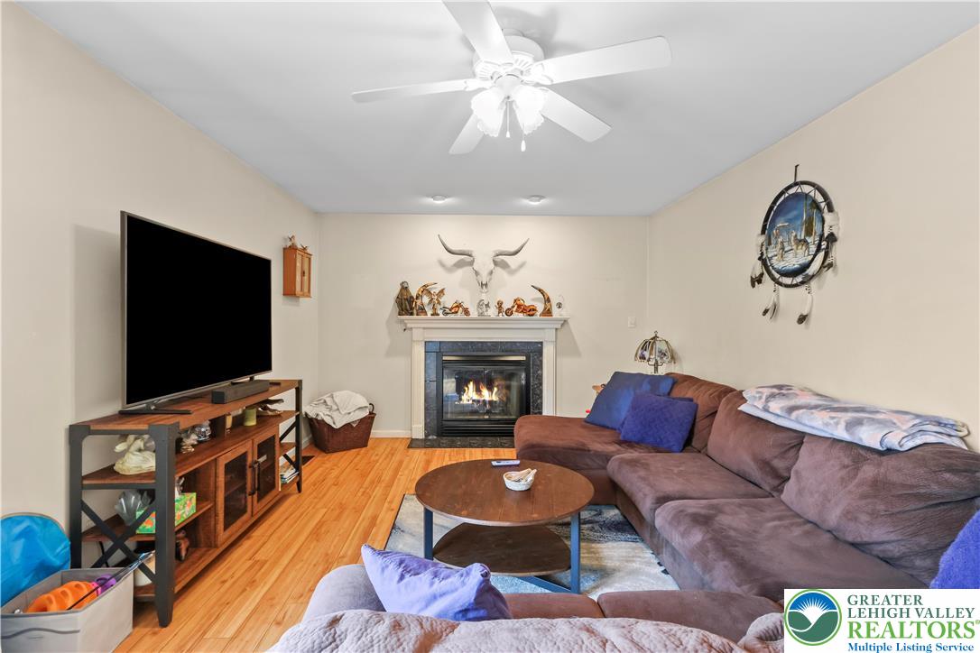 1712 9th Street Bethlehem, PA 18020 - Photo 5 of 38 a living room with furniture a flat screen tv and a fireplace