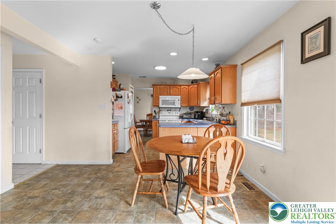 1712 9th Street Bethlehem, PA 18020 - Photo 8 of 38 a dining room with stainless steel appliances a dining table chairs refrigerator and kitchen view