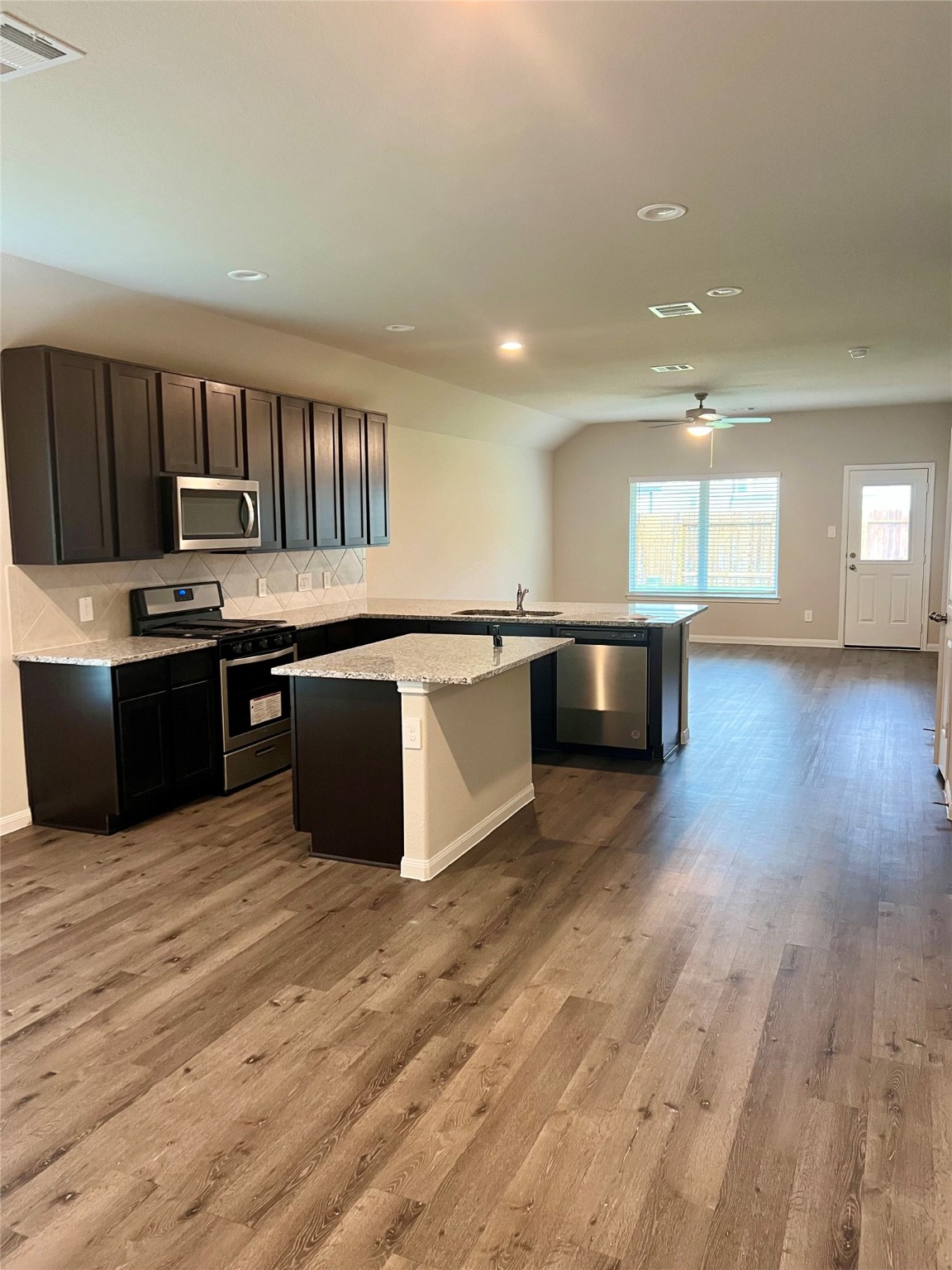 5603 Brooklyn Rose Drive Rosharon, TX 77583 - Photo 2 of 11 a kitchen with stainless steel appliances granite countertop a sink and a stove top oven