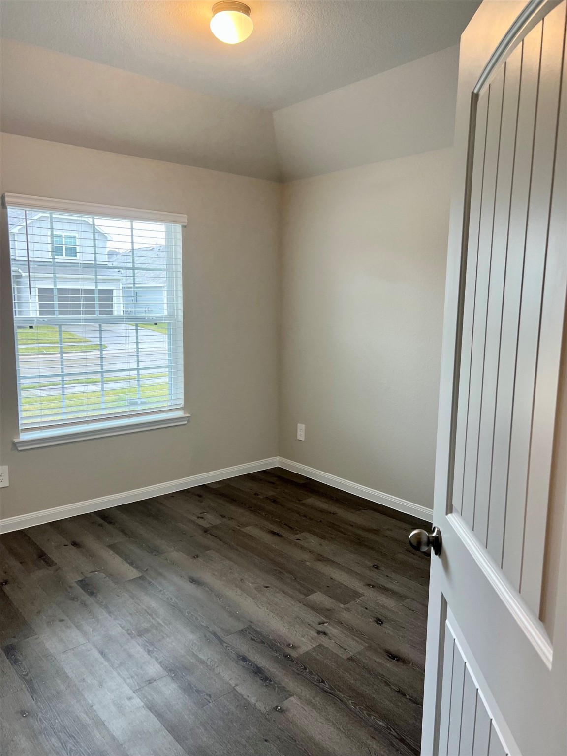 5603 Brooklyn Rose Drive Rosharon, TX 77583 - Photo 3 of 11 an empty room with wooden floor and windows