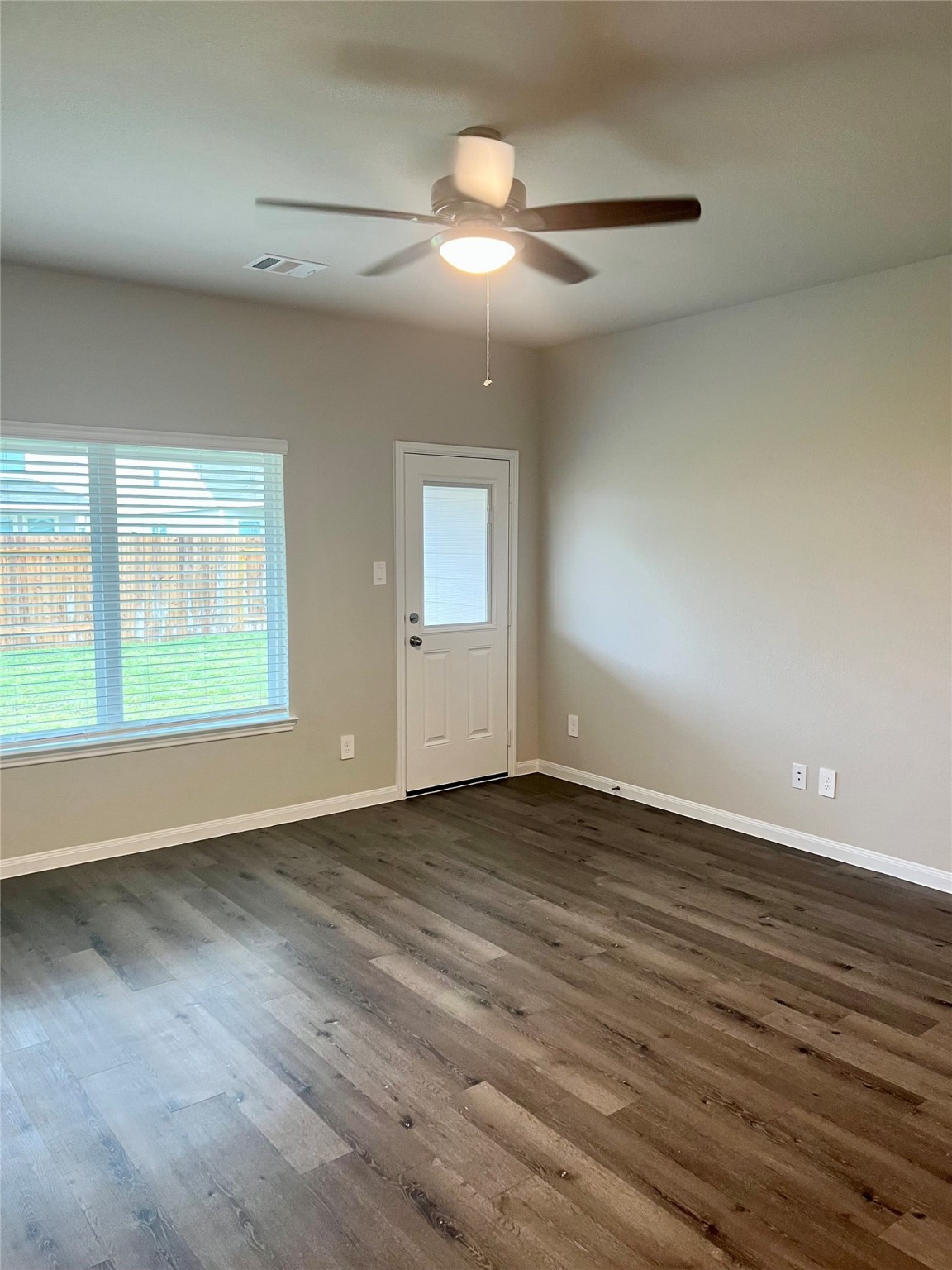 5603 Brooklyn Rose Drive Rosharon, TX 77583 - Photo 5 of 11 wooden floor in an empty room with a window