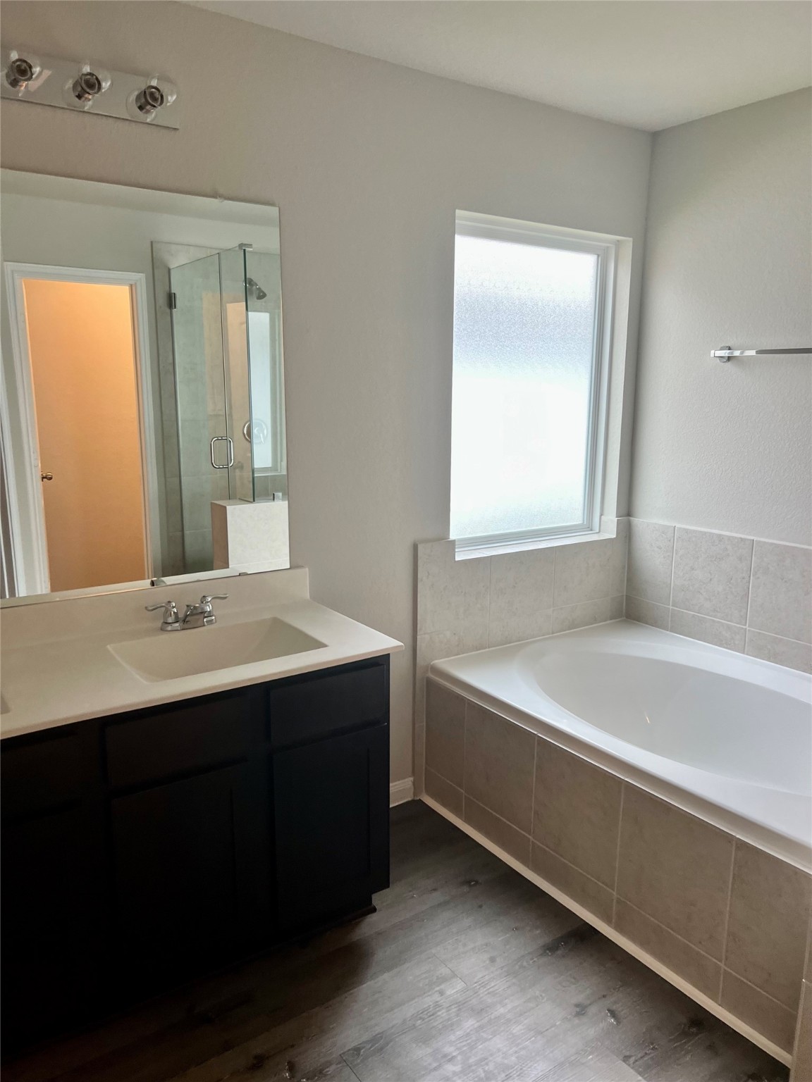 5603 Brooklyn Rose Drive Rosharon, TX 77583 - Photo 8 of 11 a bathroom with a bathtub a sink and a window