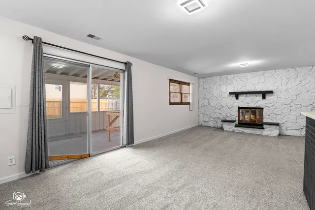 an empty room with furniture and a fireplace