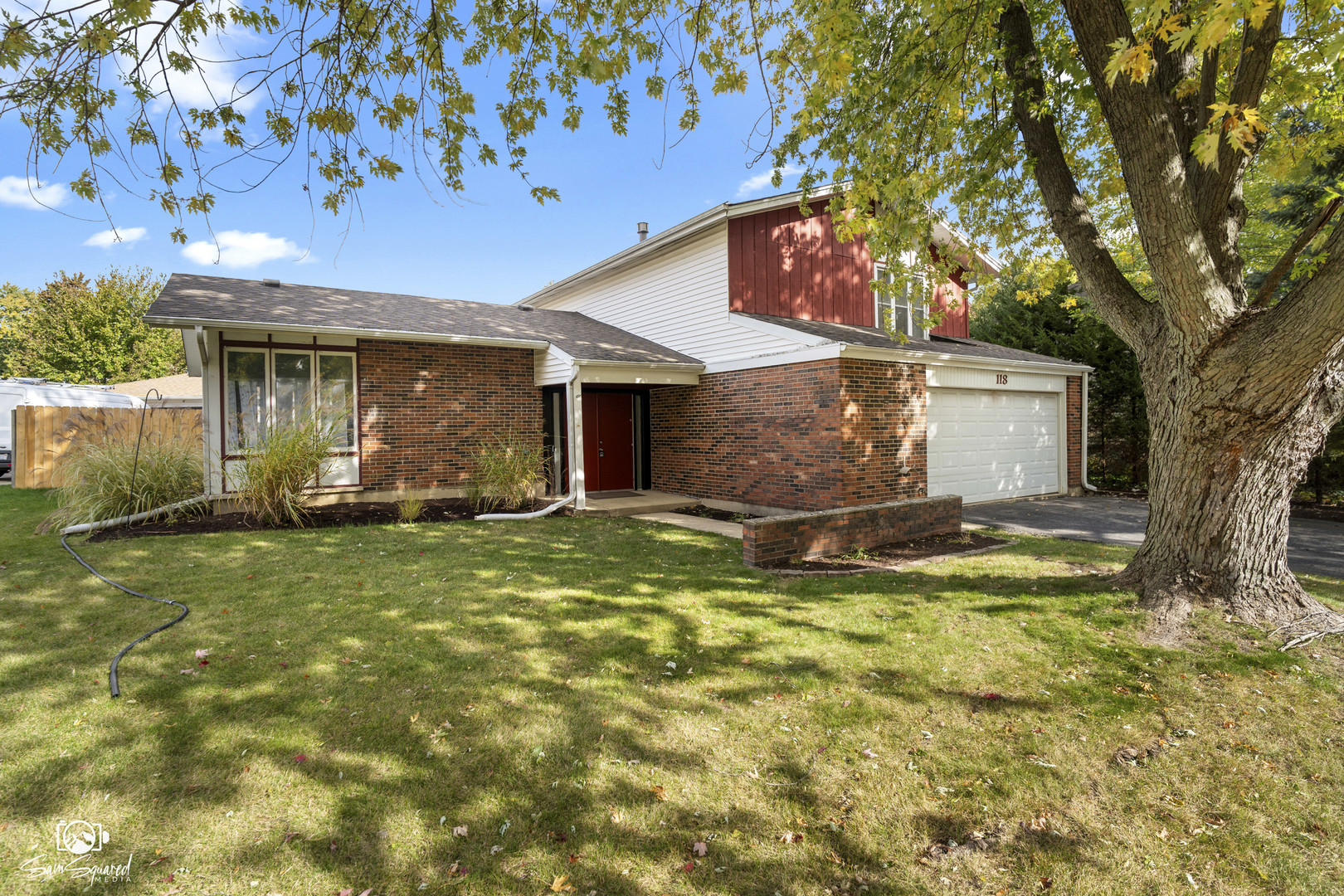 118 Camelot Way Bolingbrook, IL 60440 - Photo 2 of 32 a view of a yard in front of a house with large tree