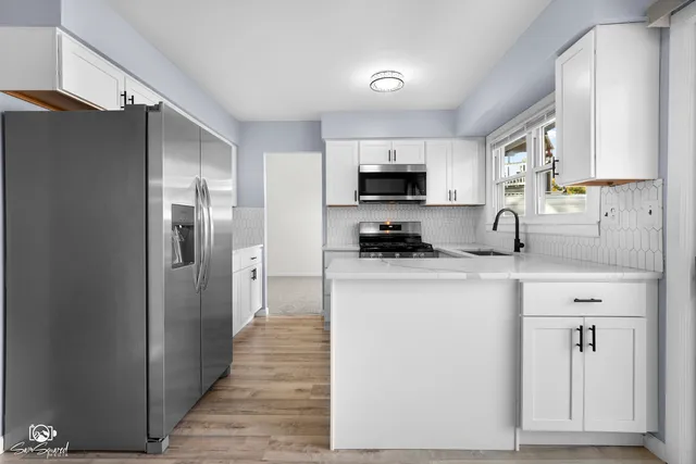 a kitchen with stainless steel appliances a refrigerator stove and sink