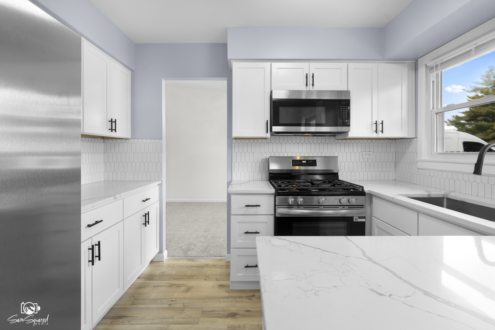 118 Camelot Way Bolingbrook, IL 60440 - Photo 6 of 32 a kitchen with stainless steel appliances granite countertop white cabinets a stove a microwave and a refrigerator