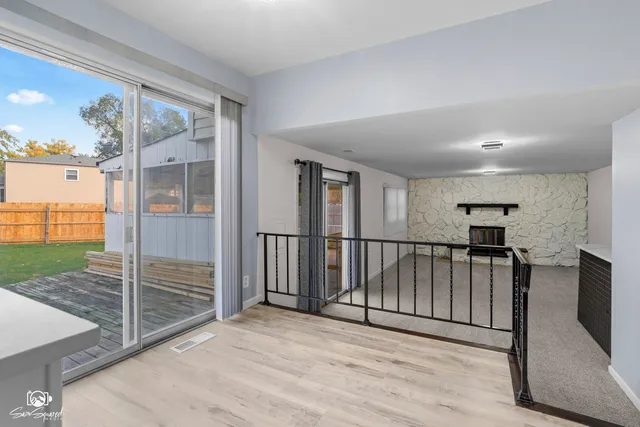 a view of a hallway with wooden floor and entryway