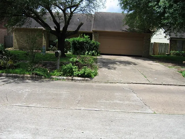 a front view of a house with a yard and a garage