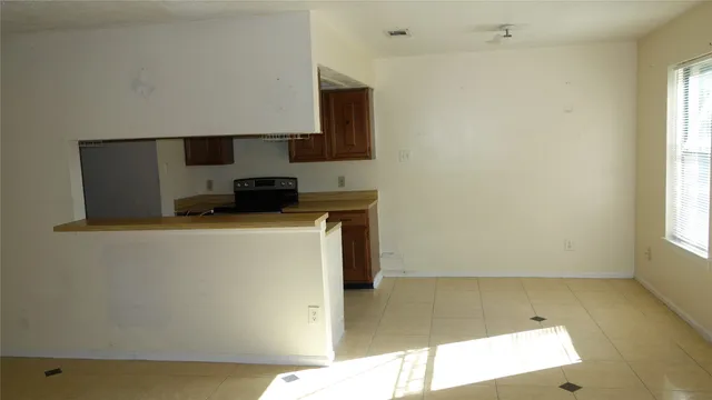 a kitchen with a sink a stove and a window