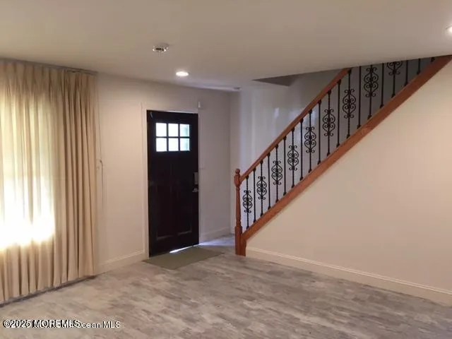 a living room with furniture and a mirror