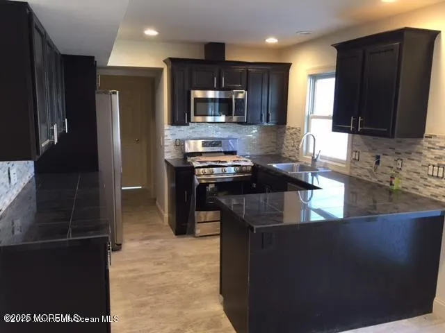 a kitchen with a sink and a refrigerator