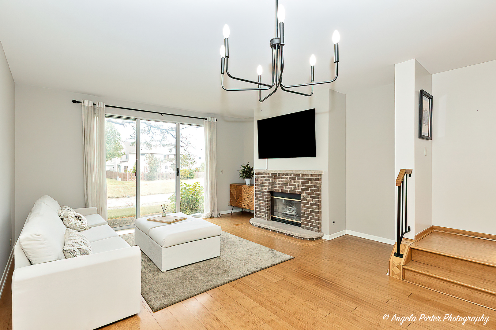 17838 Braewick Road, Unit 16017 Gurnee, IL 60031 - Photo 13 of 28 a living room with furniture a flat screen tv and a fireplace