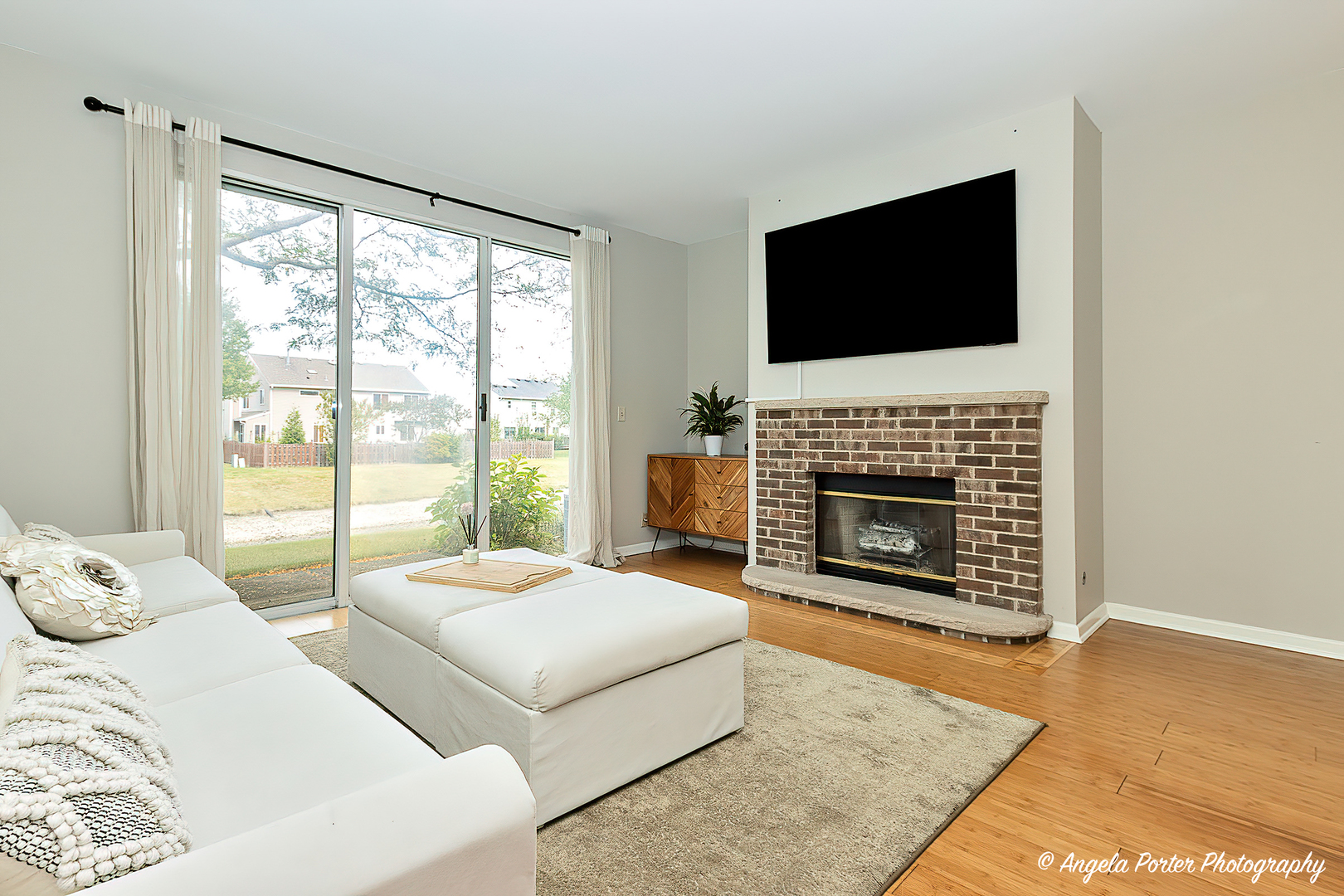 17838 Braewick Road, Unit 16017 Gurnee, IL 60031 - Photo 14 of 28 a living room with two flat screen tv and a fireplace
