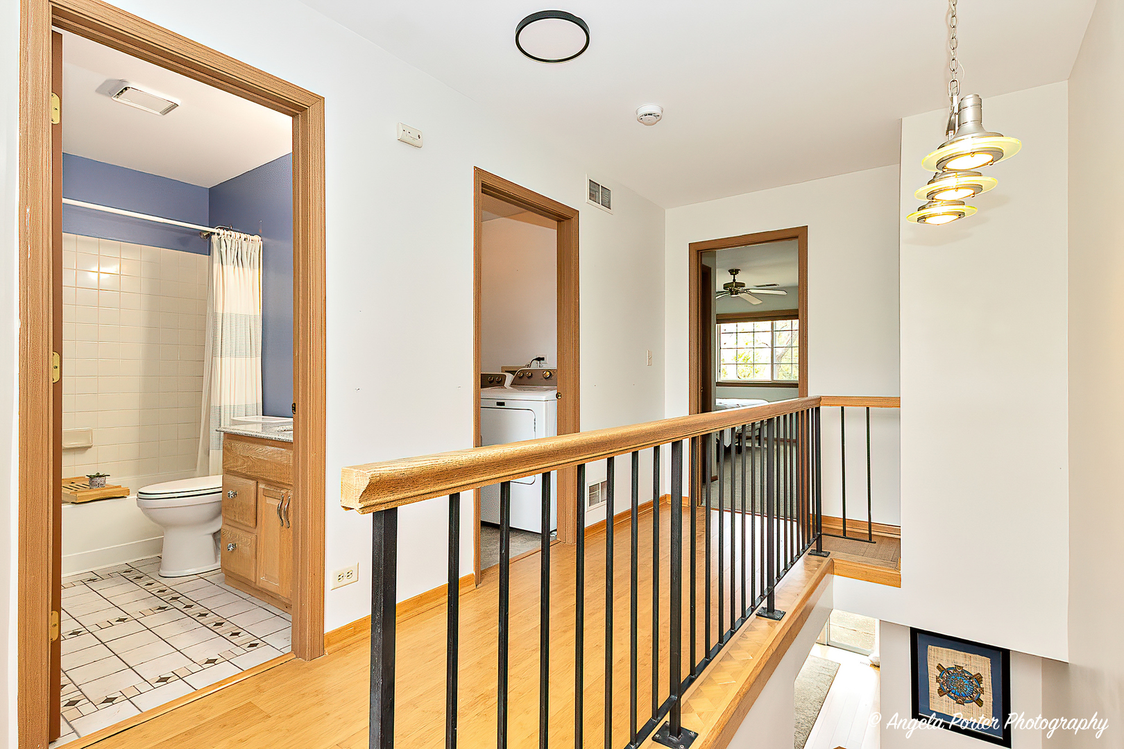 17838 Braewick Road, Unit 16017 Gurnee, IL 60031 - Photo 20 of 28 a view of a hallway with wooden floor and a bathroom